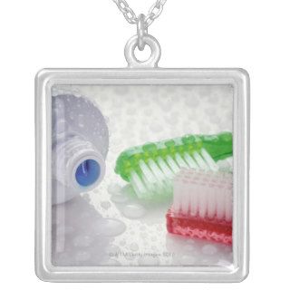 Close up of toothpaste and toothbrushes covered custom necklace
