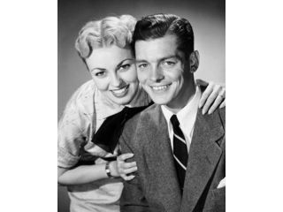 Portrait of a mid adult woman embracing a mid adult man from behind Poster Print (18 x 24)